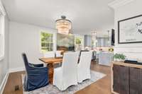 Many beautiful light fixtures are found throughout this home including this one in the dining room.