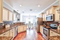 Tile backsplash, granite counters and stainless steel appliances.