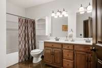 Full bath with double vanity on basement level