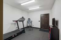 Workout room/ Bedroom on basement level with door to exterior lower level driveway