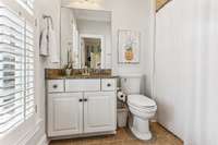 The Ensuite Bath has a granite top vanity with drawer and cabinet storage, tile flooring and a tub/shower combo with tile surround and chrome fixtures.