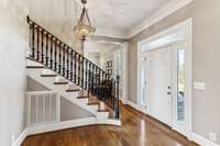 What a beautiful welcome. From the wood door with sidelights,   transoms and extensive hardwood flooring to the elegant chandelier, beautiful staircase with hardwood treads and wrought iron railing, you are greeted with classic southern charm.