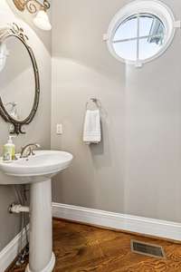 This perfectly positioned Powder Room is located near the Friend’s Entry and Drop Zone. The pedestal sink and beautiful mirror create a touch of glamour.