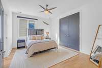 Upstairs bedroom with doors that can open to downstairs living space