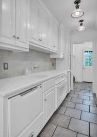 THIS EXTENSION OF THE KITCHEN FEATURES A 2ND DISHWASHER, ANOTHER OVEN (ALREADY DOUBLE OVENS IN MAIN KITCHEN) , SINK WITH TONS OF COUNTER & CABINET SPACE, & A HALF BATH. PERFECT FOR HELP WITH THE BIG PARTY!