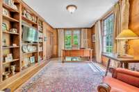 GREAT MAIN LEVEL STUDY/LIBRARY OPENS TO COVERED PORCH. THE TWO CLOSETS IN THIS ROOM FEATURE BUILT IN DRAWERS & SHELVING