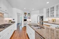 BUILT IN DESK AND SO MANY CABINETS & STORAGE. LONG SERVING COUNTER ON THE RIGHT SIDE OF PHOTO