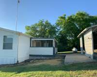 There is a carport conveniently located just outside the covered back porch.