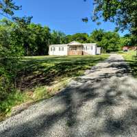 This quaint home is nestled back off the quiet road behind trees. You will be able to enjoy quiet country life with easy access to getting into three different towns.