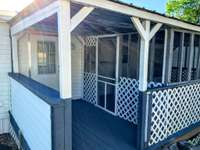 Covered back porch and screened-in porch. Just imagine watching the sunrise here.