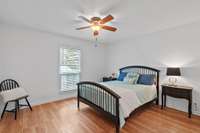 The primary bedroom boasts the same beautiful wood floors as the living space.