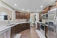 Spacious kitchen with sleek white granite countertops