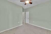 In addition to a ceiling fan,there is also a closet to the left.