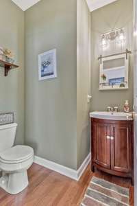 Guest half bathroom with newer vanity located off the foyer.