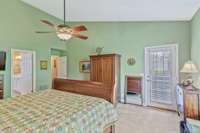 Another view of the main level primary bedroom with pedestrian door that leads out to deck and private backyard!