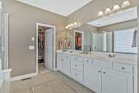 Huge primary bedroom's private bathroom.  Extra long vanity, water closet and ceramic tile floor, plus walk in closet!