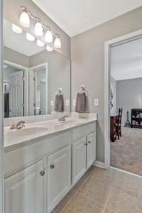 Full bathroom with double sinks located in between 2 of the upstairs spare bedrooms.