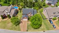 Aerial view shows extra wide driveway for additional parking and backyard privacy.