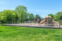 Neighborhood playground with swings, picnic tables and lots of open space