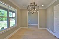 Spacious dining room with custom lighting.