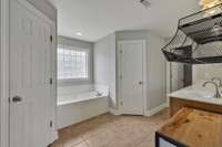 Large principal bath with soaker tub and his & hers closets.