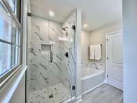 Beautiful tiles shower and soaking tub.