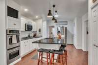 Kitchen features under cabinet, lighting, new backsplash, double oven and gas cooking.