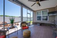 Back screened in patio area with decorative concrete floor (just pressure washed), ceiling fan, privacy curtains, cable TV (tv remains with property). Door leads to back patio and fenced back yard.