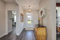 Front Foyer entry way features "bench drop area", upgraded light fixtures