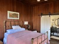 This bedroom is located in small guest house along with a full bath