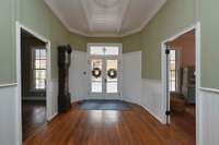 The front and rear doors of hall are flanked by closets original to house.