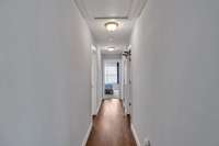 Hallway leading to bedrooms 2 & 3 and the laundry room with attic access.