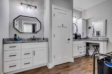 Separate his and hers vanities, with large linen closet