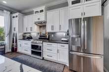 Stainless Steel appliances and tall white soft close cabinets