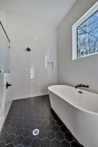 The dual showers and tub in the wet room elevate the style and convenience in the primary bath.