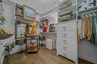 Large walk-in closet with California closet systems. Also acts as a sewing room!