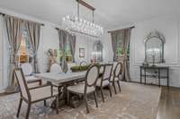 Inspired by art deco style of the 1920s this formal dining room includes a restoration hardware crystal chandelier,  and restoration hardware custom-sized rug + recessed panel hidden cabinets.