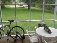 Screened patio large enough for breakfast table.