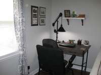 Desk in corner of living room for office or study area.