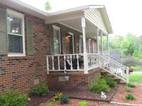 Beautiful landscaping leads to covered front porch!!