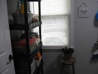 Laundry room has room for additional storage shelf.