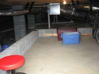 Under home concrete pad for additional storage and it is lit for your convenience. Dry as a bone!!