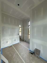 Guest Bath with large walk-in shower and free standing tub. *this home is under construction Photo taken 9/5/24