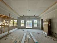 Bonus Room with beam detail connecting to a Sun Deck on the  second level. *this home is under construction Photo taken 9/5/24