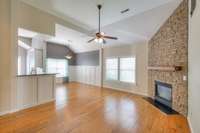 Freshly painted great room with full stone fireplace wall