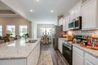 Stock photo showing kitchen to dining area.