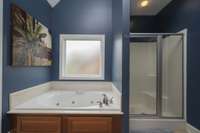 Primary bath has a whirlpool garden tub and separate shower.