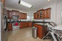 View of kitchen from garage door and back hallway.