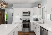 Awaiting you in the airy kitchen, complete with a monochromatic white backsplash and sleek cabinetry with brushed nickel hardware, you'll find a glass-topped electric range for the practical chef who aims to cook and clean with minimal complications.