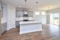 Staggered height cabinets and granite included in the kitchen! Very open to casual dining and great room *Photo not of actual home